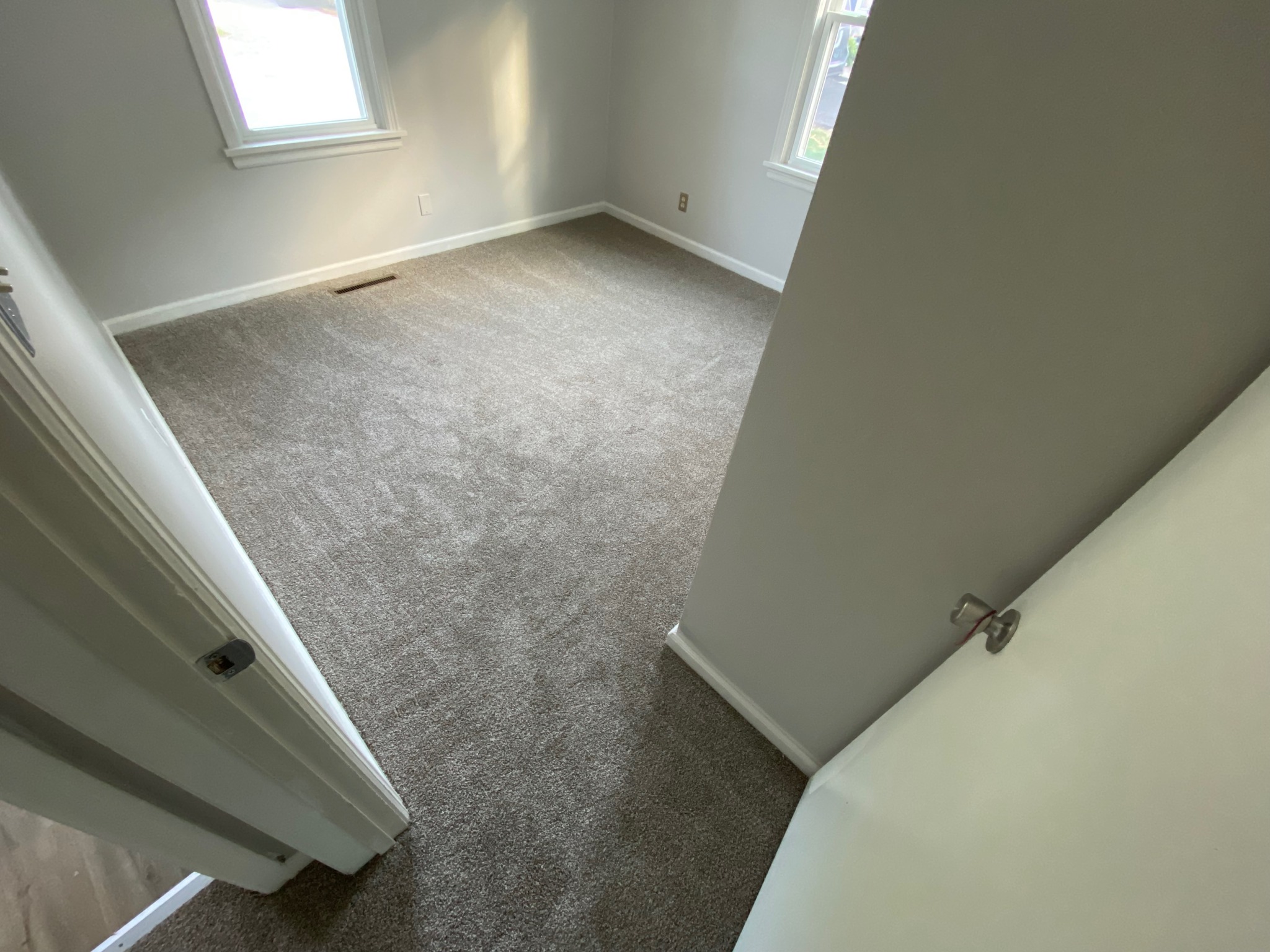 New carpet in a bedroom and hallways of a home.