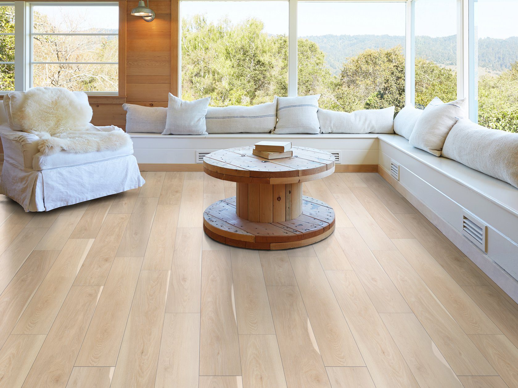 Shaw luxury vinyl plank in Alabaster from the Pantheon HD+ Natural Bevel Collection shown in a modern living room setting.