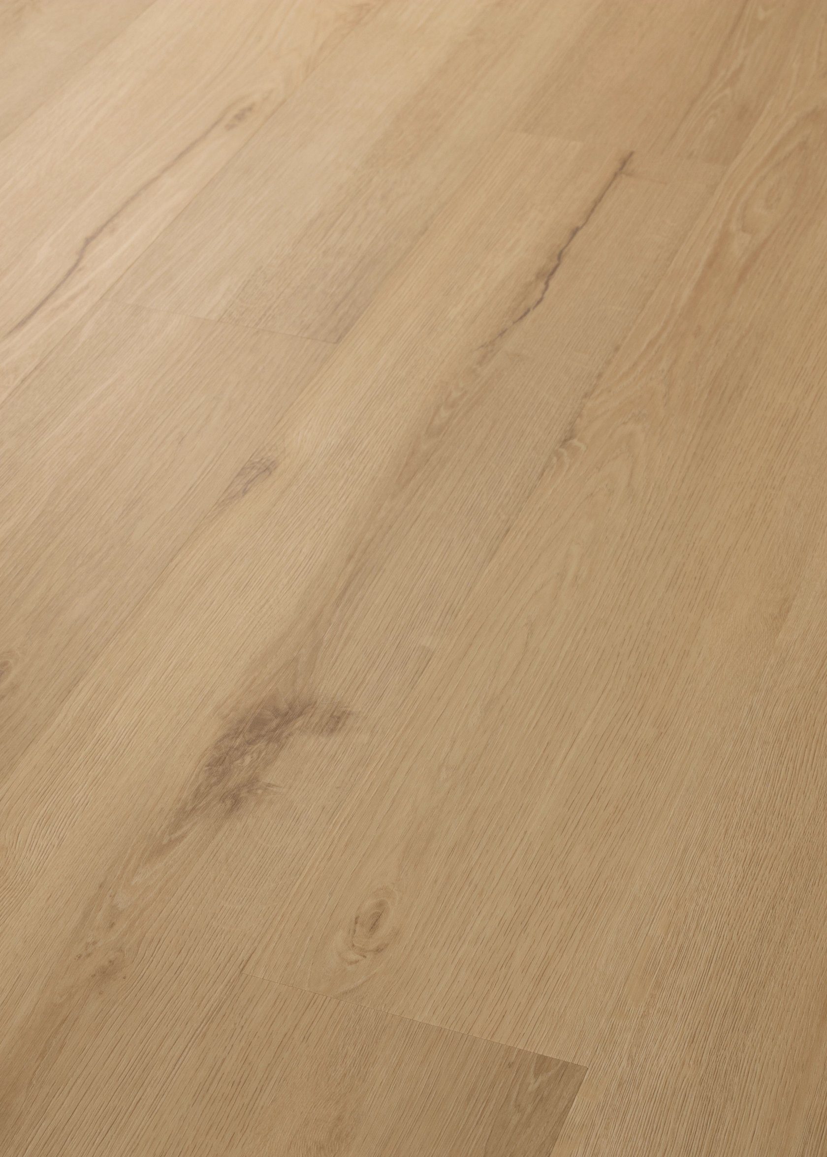 Shaw glue down LVP Fleetwood, in color sunbaked oak, close up photo at an angle.